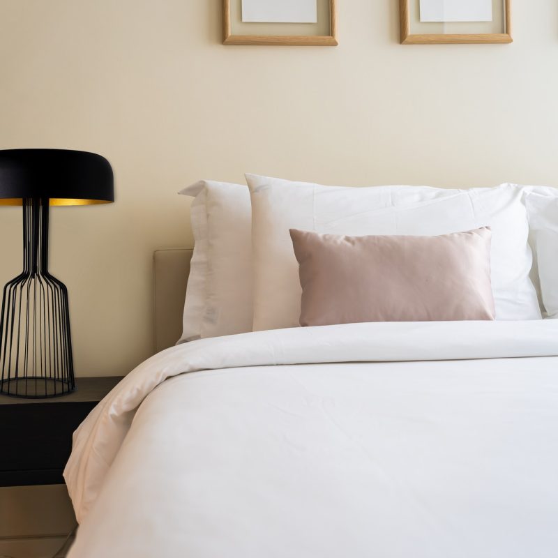 White comfortable pillow on bed decoration interior